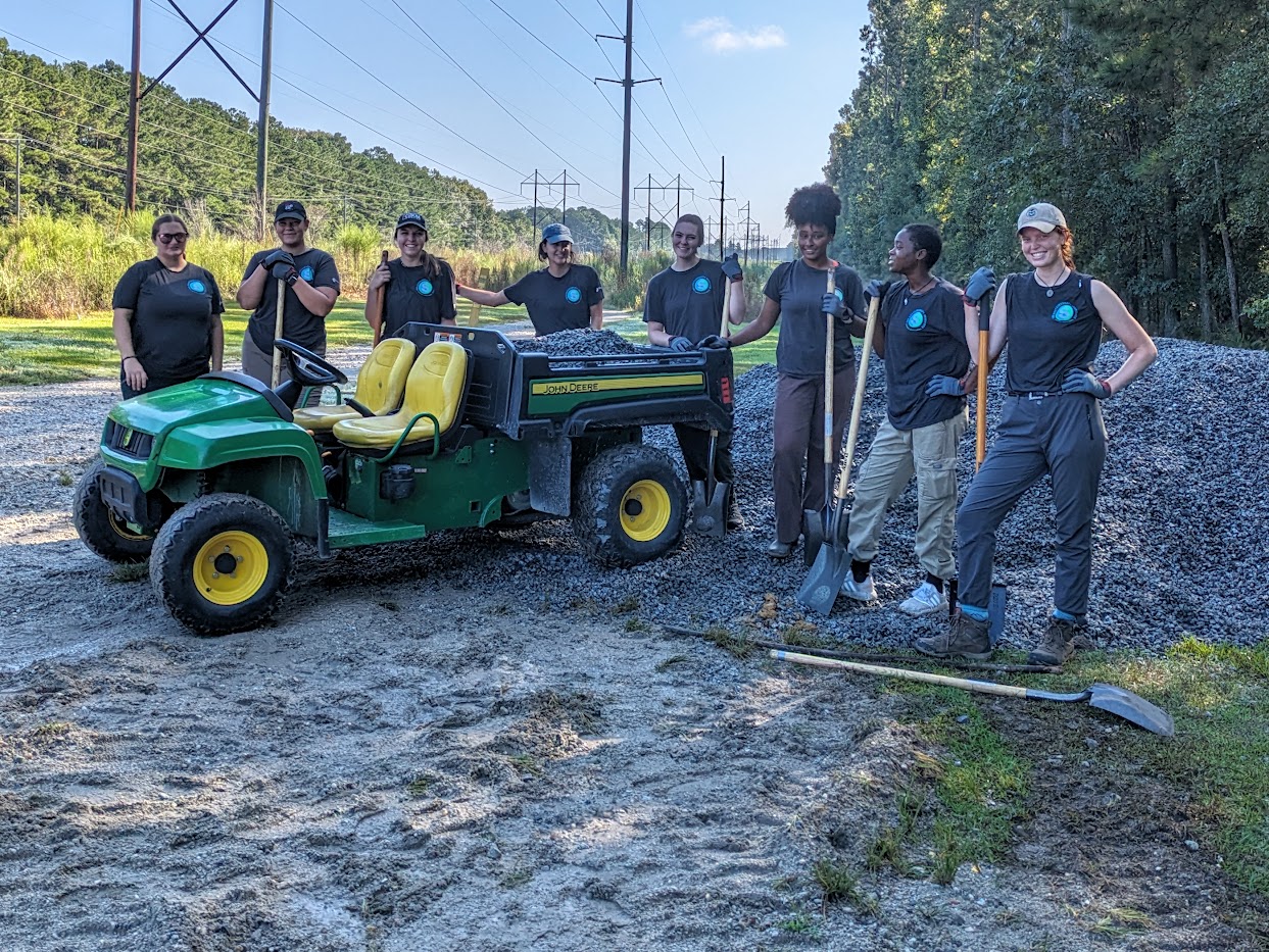 Volunteers posing on a newly built trail feature
