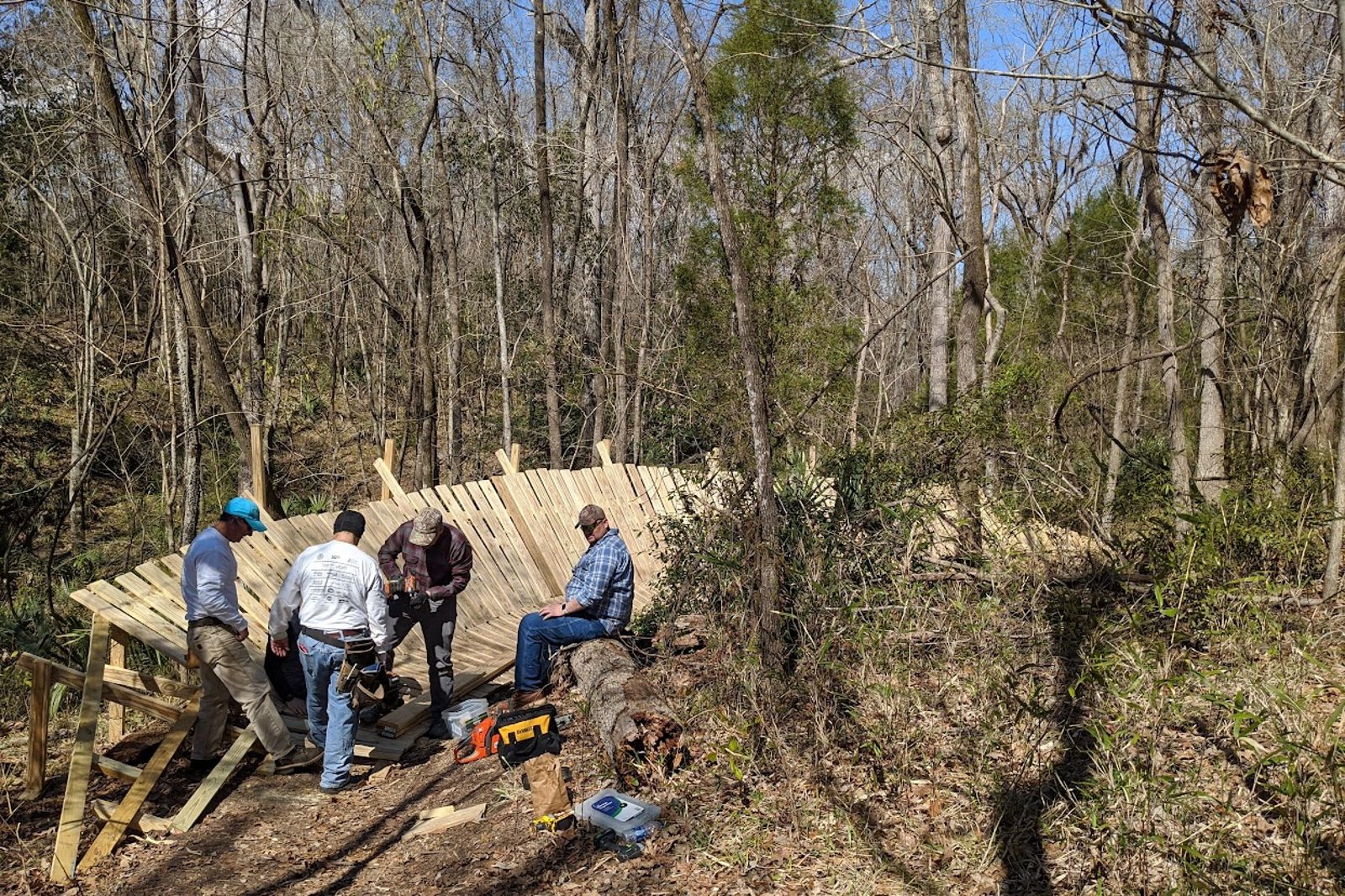 Volunteers building a wooden trail feature