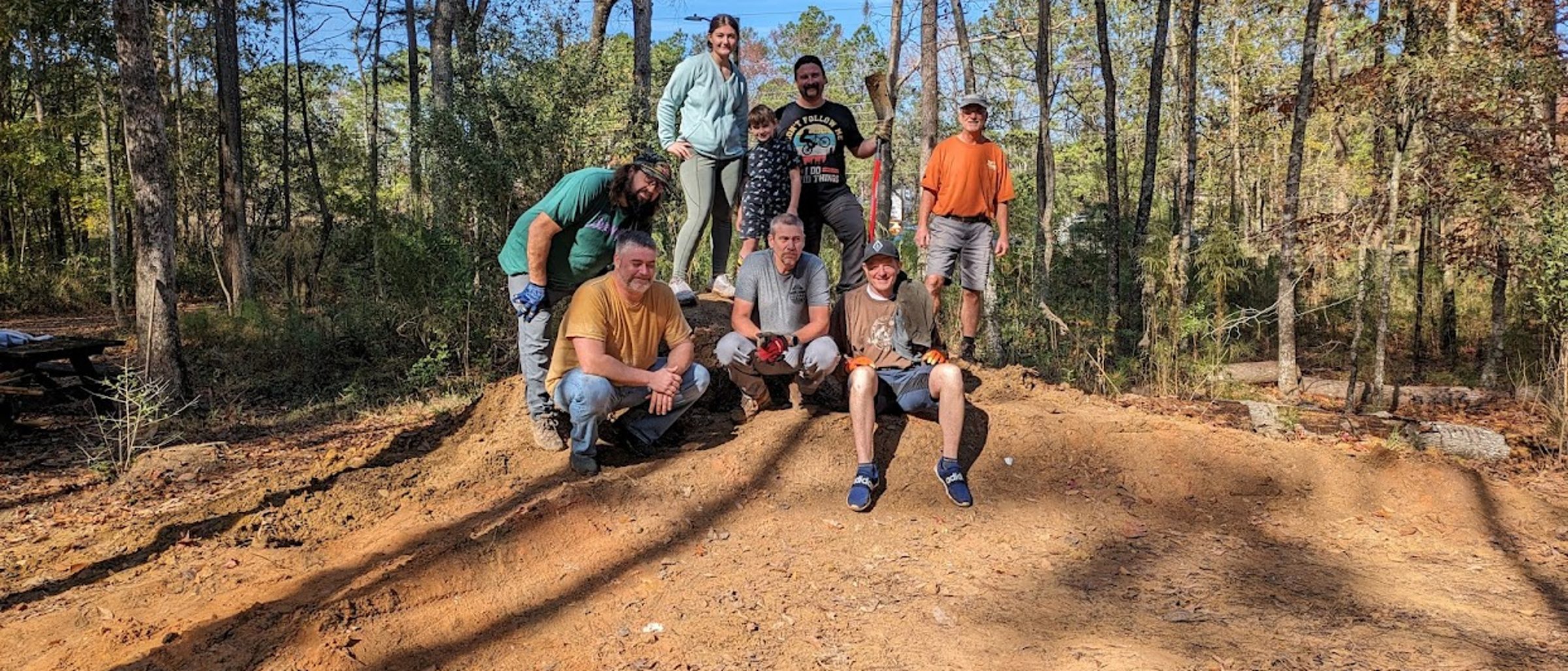 Volunteers building and shaping trail features
